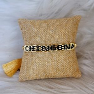 SEED BEAD ADJUSTABLE BRACLET WITH TASSELS.